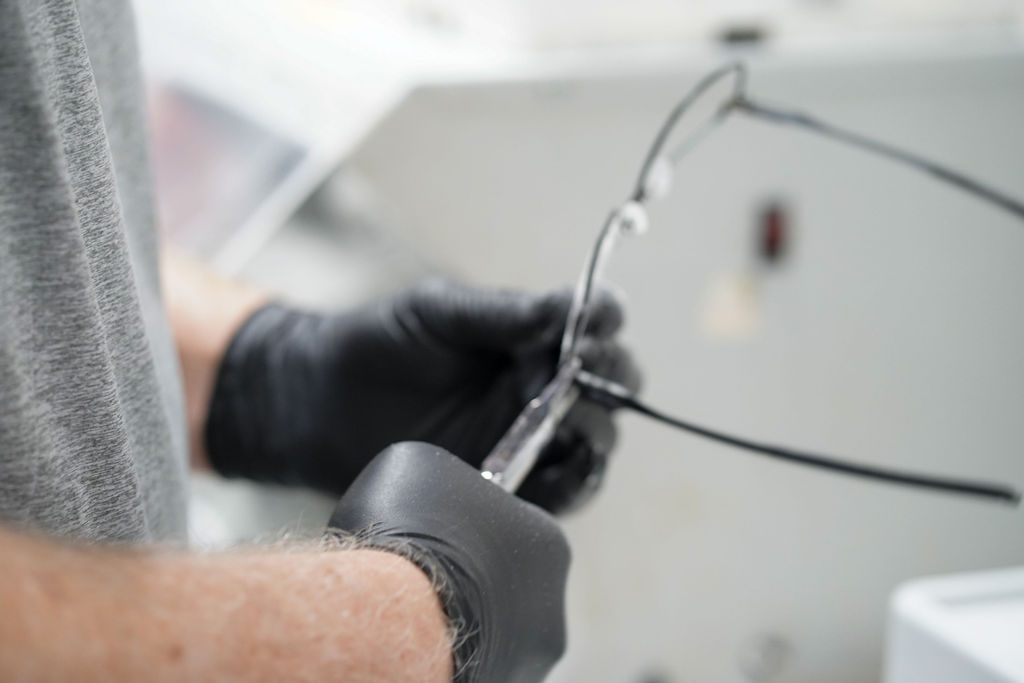 Edging a metal frame by hand in the Utah lab