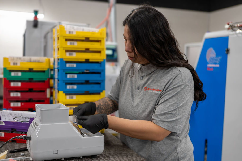 Lab technician operating an edging machine
