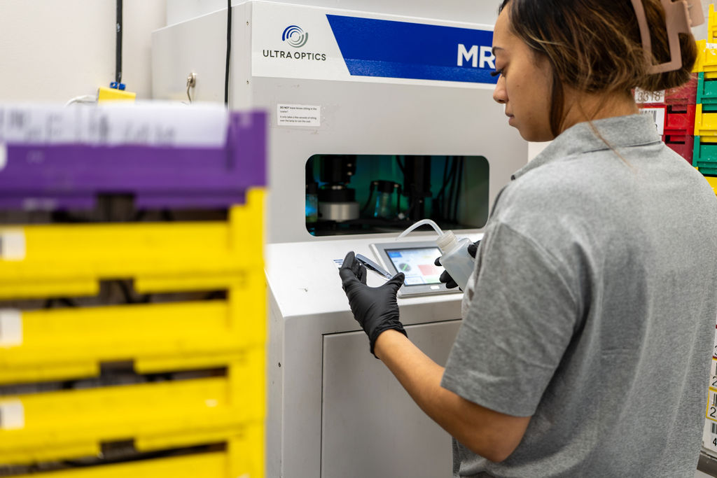 Technician loading the Ultra Optics MRX anti-reflective coater